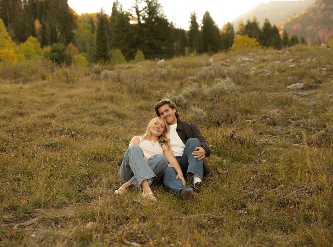 Garrett and Adeline sitting in a meadow